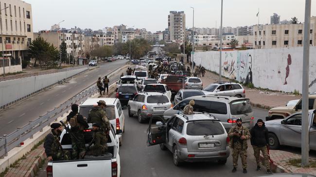Fighters with the new Syrian government mobilise in the Tartus region of Syria. Picture: Ali Haj Suleiman/Getty Images
