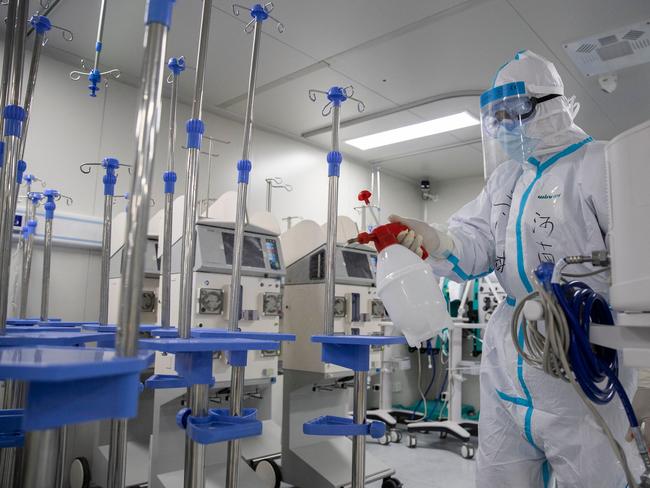 A staff member spraying disinfectant on medical equipment at a Wuhan hospital. Picture: AFP