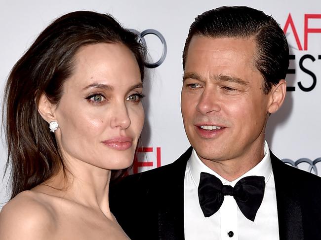 (FILES) This file photo taken on November 04, 2015 shows actress Angelina Jolie Pitt and husband actor Brad Pitt at the AFI FEST 2015 presented by Audi opening night gala premiere of Universal Pictures' "By The Sea" at the Chinese Theatre in Los Angeles, California.   Brad Pitt has accused Angelina Jolie of compromising their children's privacy and is asking a judge to seal details about the youngsters emerging from the couple's divorce, court papers showed Thursday.  / AFP PHOTO / KEVIN WINTER