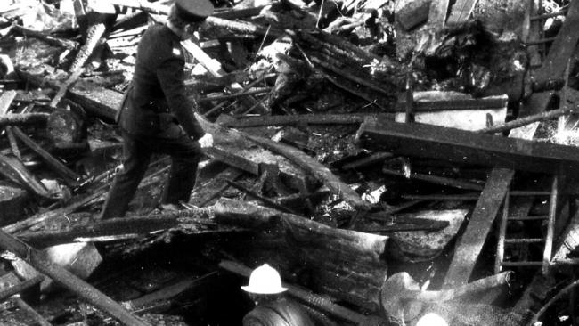 Firemen sift through remains of ghost train ride at Luna Park, Sydney, 10/06/1979 after fire destroyed it killing seven people including children. Pic Uwe Kuessner.