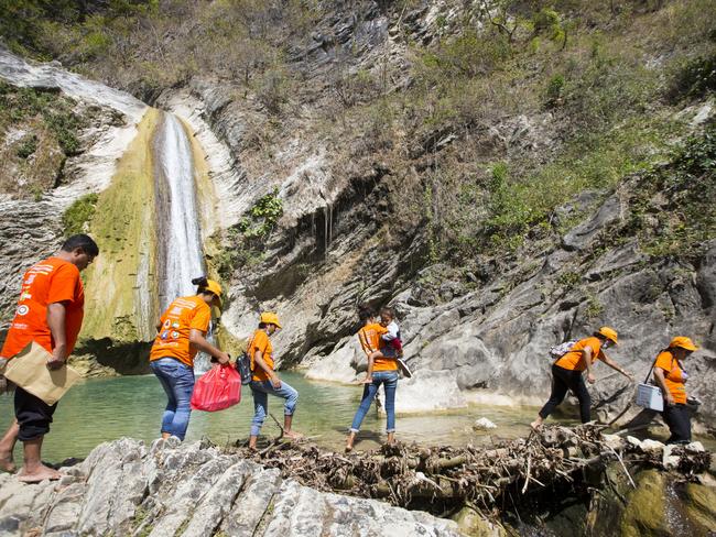 Immunisation workers travelling on foot through rivers and rough terrain in Timor-Leste. Picture: UNICEF