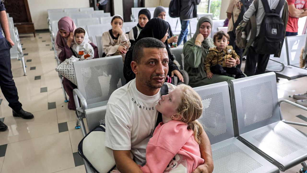 A man waits with a child at the traveller's terminal on the Palestinian side of the Rafah border crossing with Egypt in the southern Gaza Strip. Picture: AFP