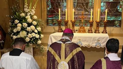 Archbishop Fisher blesses the grave of Cardinal George Pell in the crypt of St Mary's cathedral in Sydney. Picture: Tess Livingstone