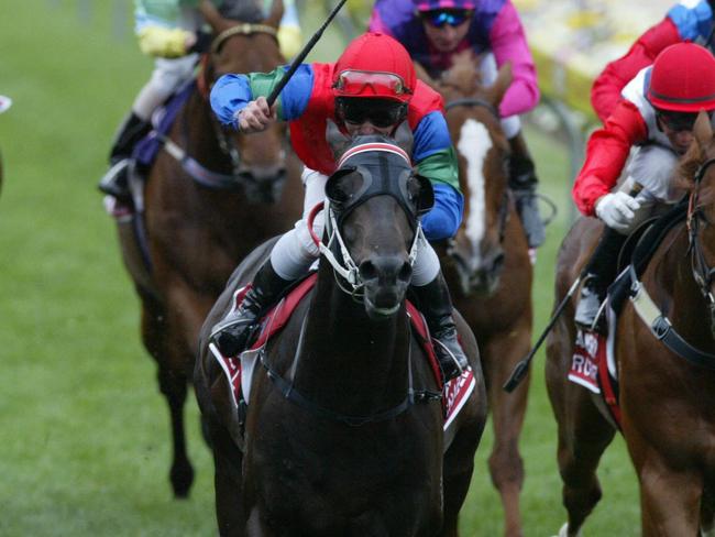 Horseracing - racehorse Savabeel (c) ridden by jockey Chris Munce winning Cox Plate race at Moonee Valley 23 Oct 2004.