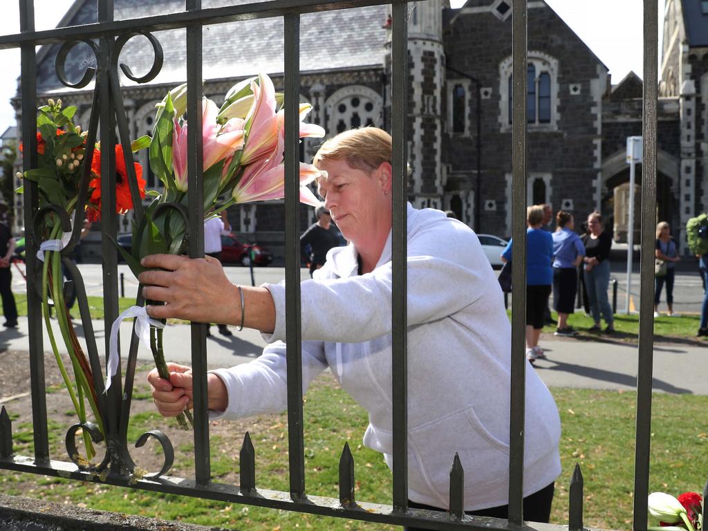 Karryn Britt from Christchurch places flowers at the mosque site. Picture: Gary Ramage