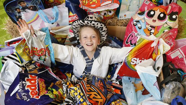 Melbourne Show show bag judging. One of the show bag judges Josh 11, buries himself in his work finding the best show bags on offer.       Picture: David Caird
