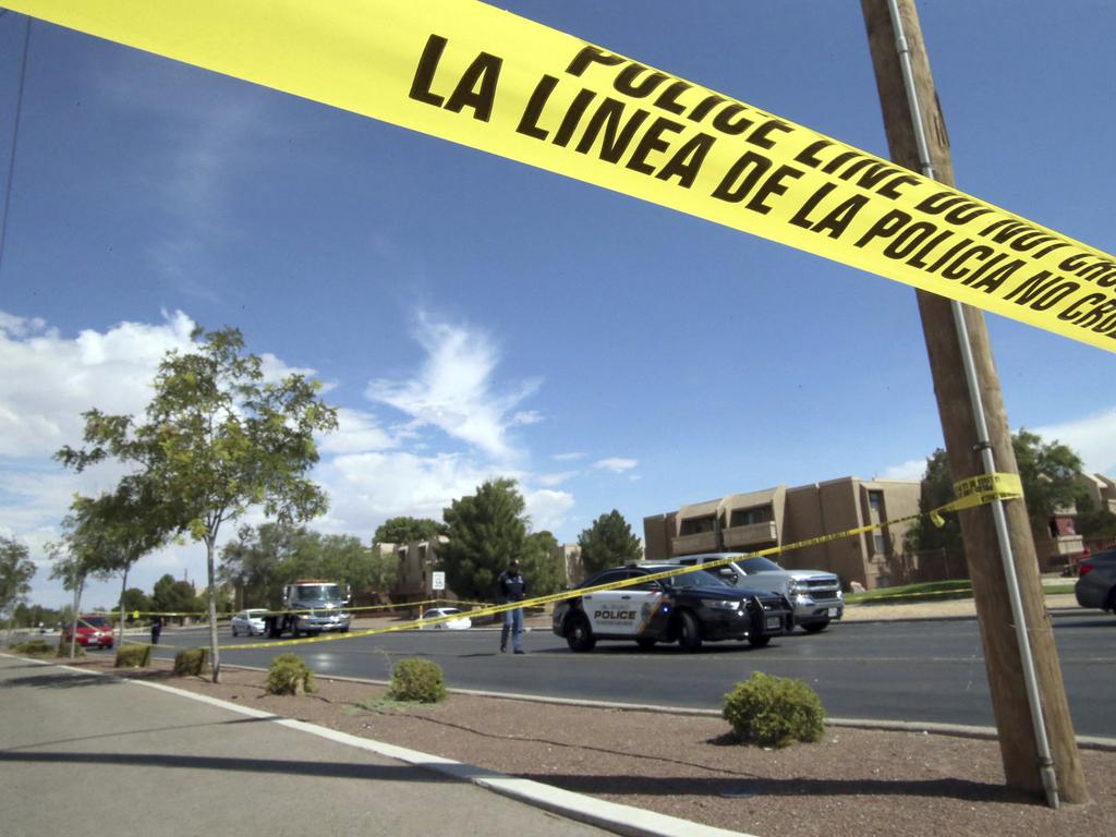 Police tape strung across an intersection behind the scene of the massacre.