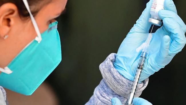 The Moderna Covid-19 vaccine is loaded into a syringe ahead of use on eligible people identified by homeless service agencies from the parking lot of the L.A. Mission on February 24, 2021 in Los Angeles, California. (Photo by Frederic J. BROWN / AFP)