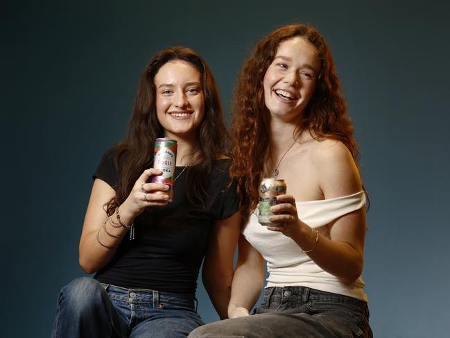 Grace O’Keeffe and Miranda Thomas sample colourful alcoholic soft drinks. Picture: Richard Dobson