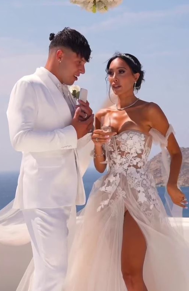 A former Neighbours star turned adult content creator has stunned in a revealing wedding dress. Picture: TikTok/ScarletVas