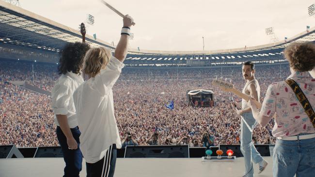 Gwilym Lee (as guitarist Brian May), Ben Hardy (as drummer Roger Taylor), Rami Malek (as singer frontman Freddie Mercury) and Joe Mazzello (as bassist John Deacon) on stage at the Live Aid concert. Photo: Twentieth Century Fox