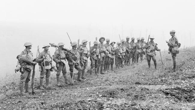 Lieutenant Rupert Frederick Arding Downes, right, briefs his men. Australian War Memorial E02790