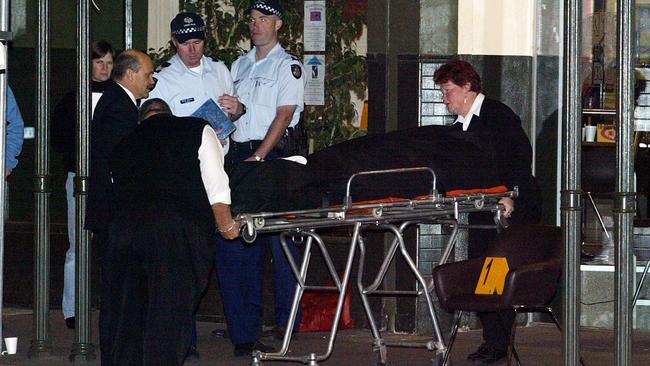 Moran’s body is wheeled out on a gurney. Picture: Ellen Smith
