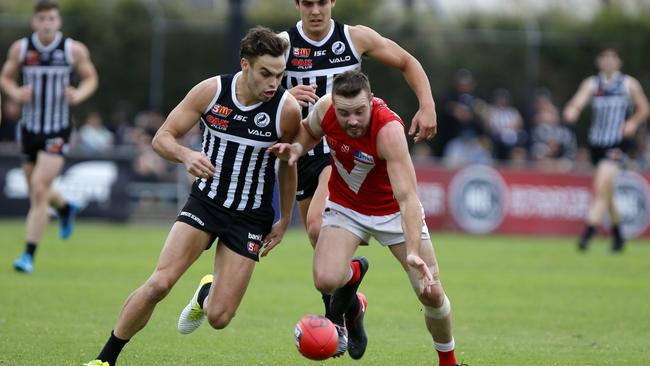 Port’s Karl Amon competes with North captain Max Thring at Alberton Oval. Picture: Deb Curtis