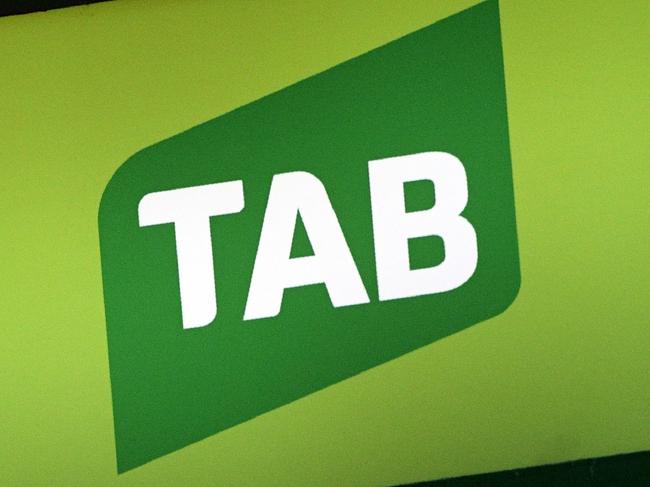 TAB signage sits above a TAB betting shop in Sydney on September 20, 2017. An Australian court on September 20 dealt a blow to a planned AUD 8.6 billion (USD 6.9 billion) merger of gambling giants Tabcorp and Tatts, ordering a review of the deal following competition concerns. / AFP PHOTO / WILLIAM WEST