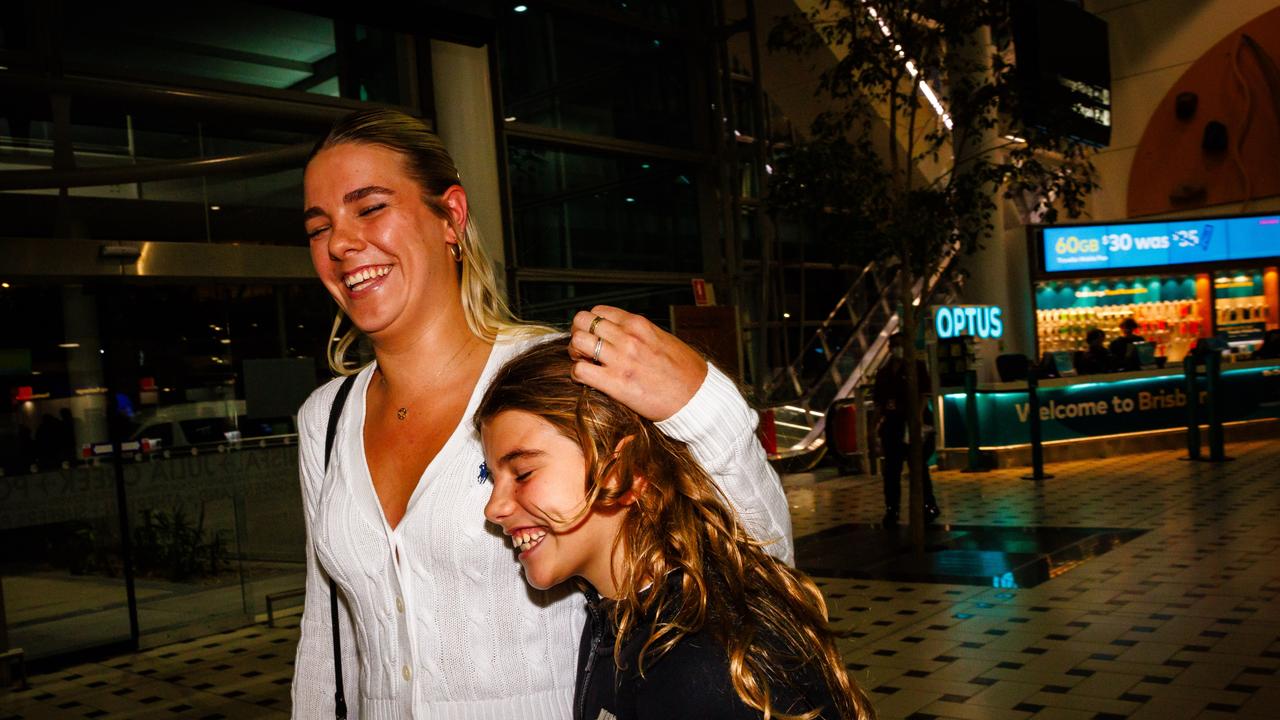 Family reunited after the third repatriation flight touched down in Brisbane. Picture: AFP via NewsWire