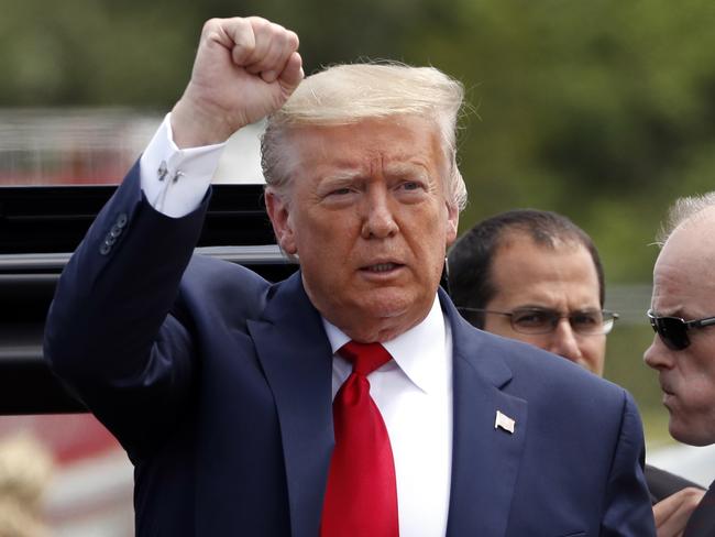 President Donald Trump makes a defiant fist as he arrives at Kennedy Space Centre. Picture: AP