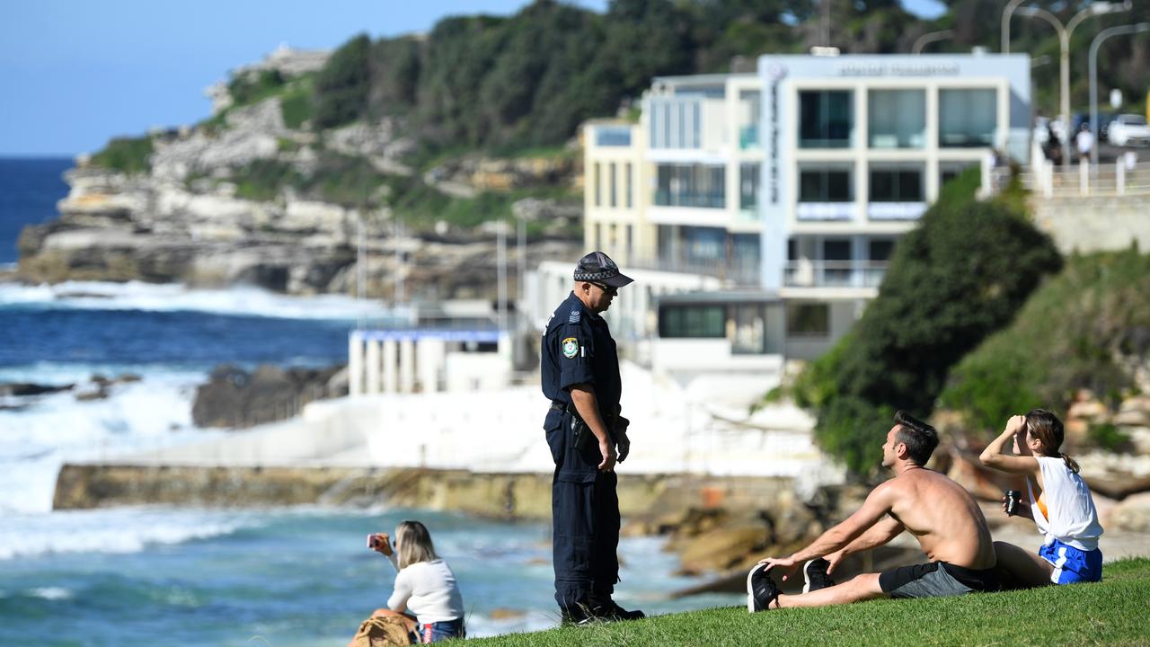 NSW Police ask people to move on while patrolling during the Easter long weekend at Bondi Beach in Sydney. Picture: Joel Carrett/AAP