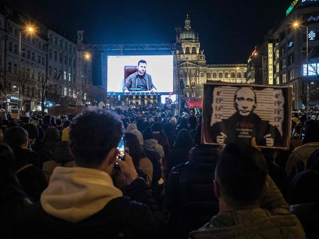 Protestors listen to a speech of Ukrainian President Volodymr Zelensky screened during a demonstration against Russia's invasion of Ukraine, on March 4, 2022 at the Venceslas square in Prague, Czech Republic. (Photo by Michal Cizek / AFP)