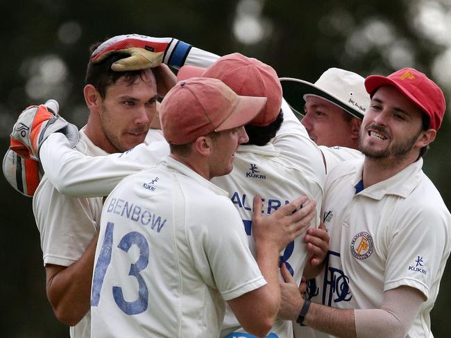 Scott Boland is mobbed by Frankston Peninsula teammates after taking a wicket in 2015. Picture: Mark Dadswell