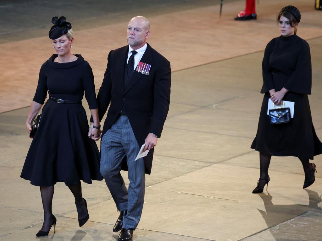 Zara Tindall and her husband Mike Tindall and Princess Eugenie walk as the procession with the coffin of Britain's Queen Elizabeth arrives at Westminster Hall from Buckingham Palace. Picture: Getty Images.