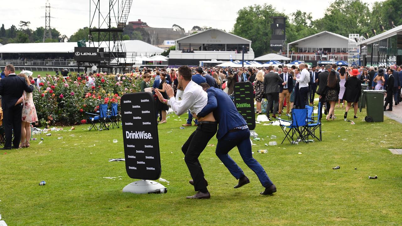 Two men tussle on the lawn. Picture: Jason Edwards