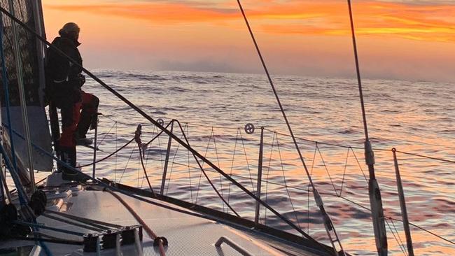 A crew member enjoying a stunning skyline at sea.