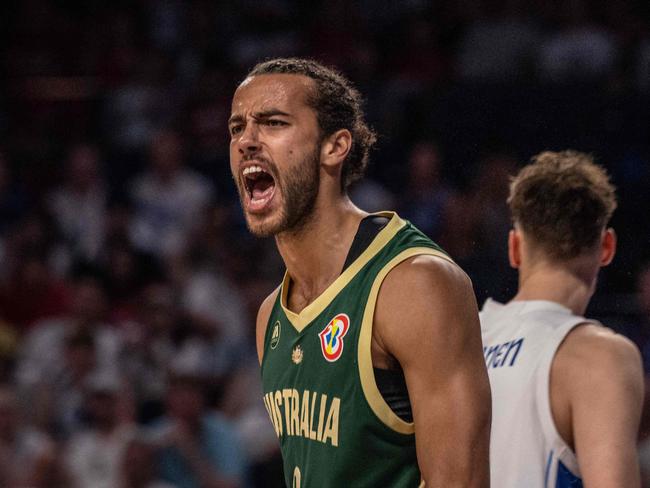 Australia's Xavier Cooks reacts after scoring during the FIBA Basketball World Cup group E match between Finland and Australia at Okinawa Arena in Okinawa on August 25, 2023. (Photo by Yuichi YAMAZAKI / AFP)