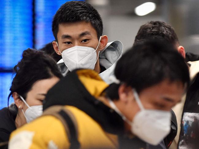 Passengers of a flight from China walk towards the COVID-19 testing centre after arriving at the Paris-Charles-de-Gaulle airport in Roissy, outside Paris, on January 1, 2023, as France reinforces health measures at the borders for travellers arriving from China. - France and Britain on December 30 joined a growing list of nations imposing Covid tests on travelers from China, after Beijing dropped foreign travel curbs despite surging cases -- and amid questions about its data reporting. (Photo by JULIEN DE ROSA / AFP)