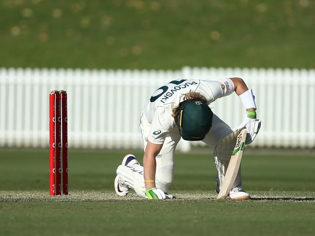 Will Pucovski of Australia A lies after he was struck in the helmet off the bowling of Kartik Tyagi.