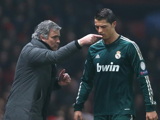 MANCHESTER, ENGLAND - MARCH 05: Real Madrid Manager Jose Mourinho gives orders to Cristiano Ronaldo during the UEFA Champions League Round of 16 Second leg match between Manchester United and Real Madrid at Old Trafford on March 5, 2013 in Manchester, United Kingdom. (Photo by Jasper Juinen/Getty Images)