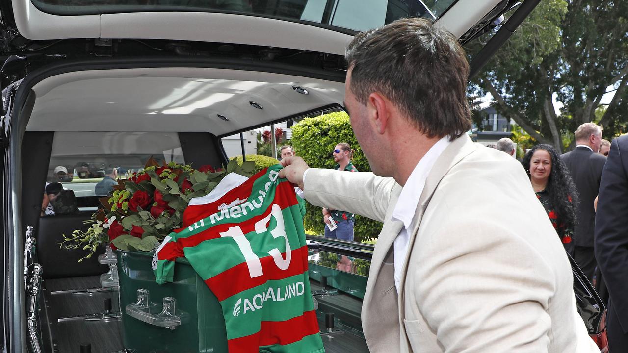 Grand child Blake Scott places the number 13 jersey on the casket during the funeral for Souths legend John Sattler on the Gold Coast. Picture: NCA NewsWire/Tertius Pickard