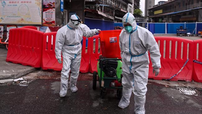 Workers take part in the disinfection of the Huanan seafood market in March 2020. Picture: AFP