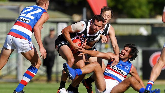 Port’s Steven Motlop takes on Central’s Jonathan Marsh and Troy Menzel. Picture: Tom Huntley