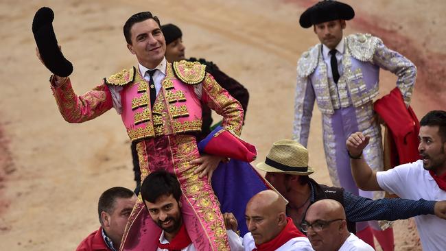 Sickening: Bullfighter Octavio Chacon is carried by assistants at the end of the bullfight. Picture: AP/Alvaro Barrientos