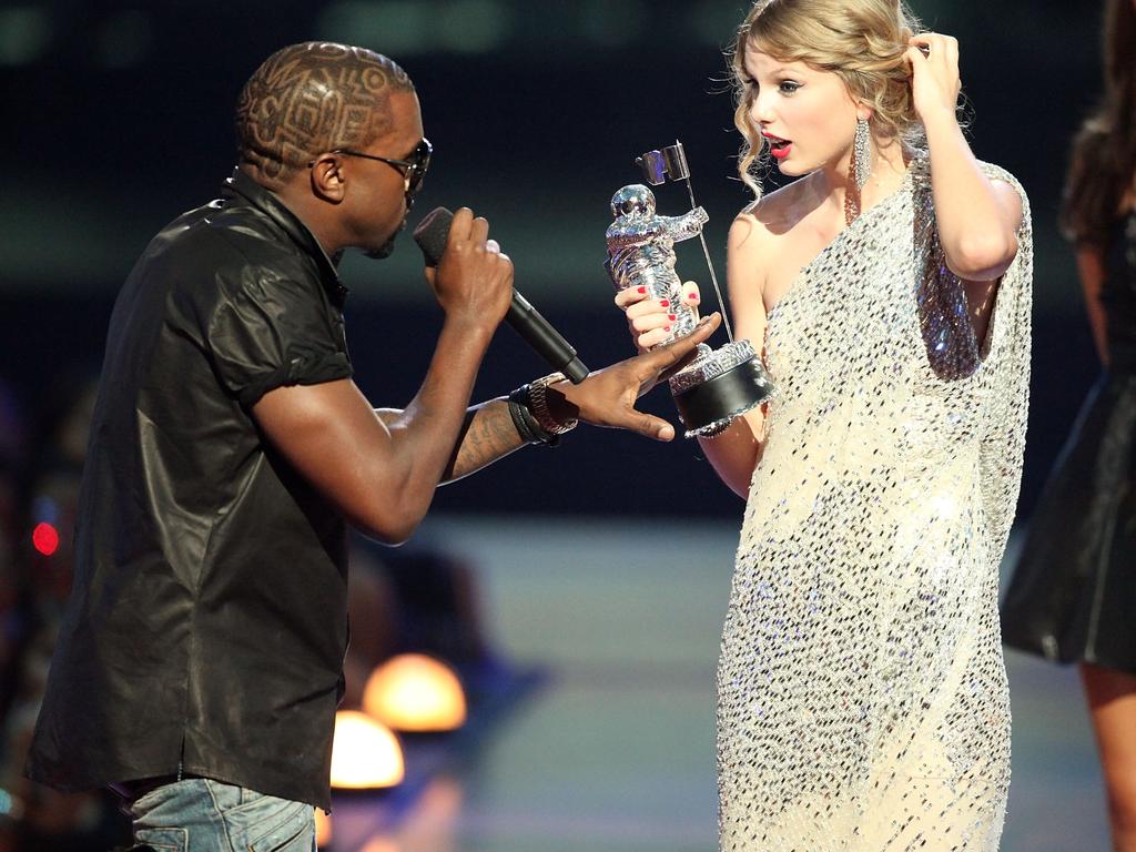 Kanye West (L) jumps onstage after Taylor Swift won the "Best Female Video" award during the 2009 MTV Video Music Awards. He was to betray her again in 2016. Picture: Christopher Polk/Getty Images