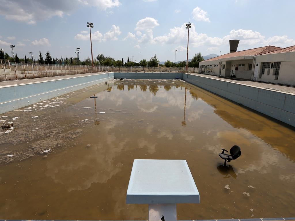 The murky waters of an abandoned training pool for athletes at the Olympic village in northern Athens