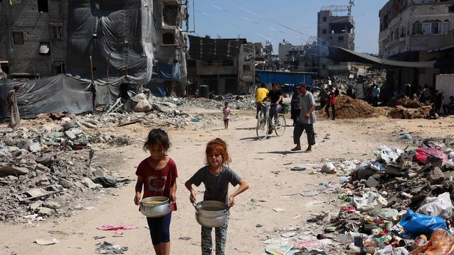 Palestinian children carry pots of soup in the Jabalia refugee camp in northern Gaza Strip. Picture: AFP