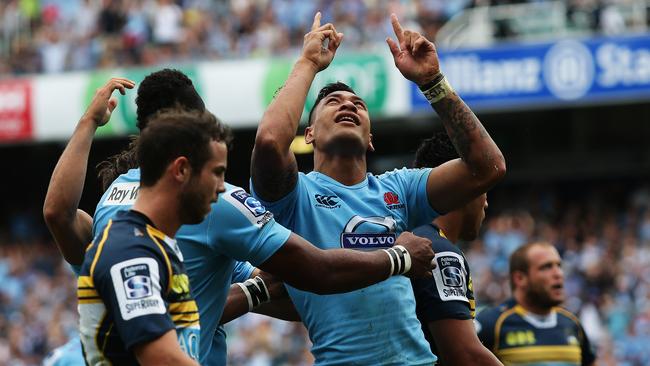 Waratah Israel Folau celebrates after scoring a try.