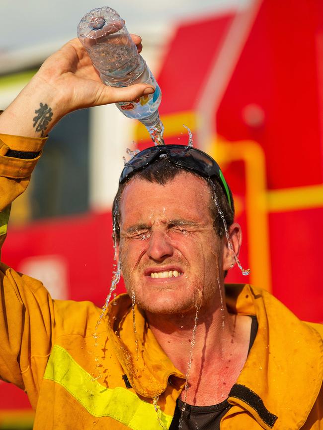 Ryan Johnstone of the Nambrok CFA cools off after returning from the fire. Picture: Mark Stewart