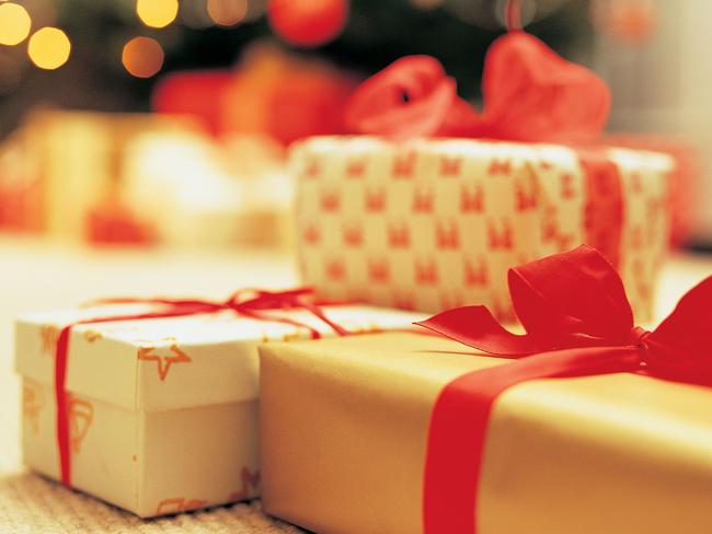 Close-Up of Presents with Christmas Tree in Background