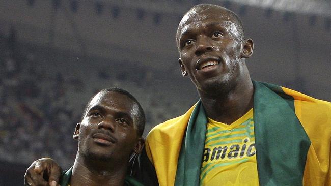 Jamaican relay teammate Nesta Carter and Bolt after the men's 4x100m relay final at the Beijing 2008 Olympics. Picture: AP