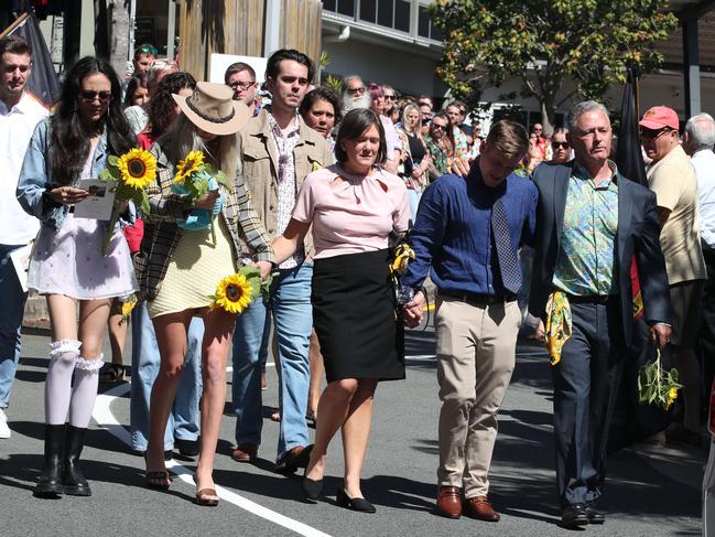 Dylan McPadden’s family hold sunflowers as they follow his hearse through a guard of honour at the Southport Church of Christ. Picture: Glenn Hampson.