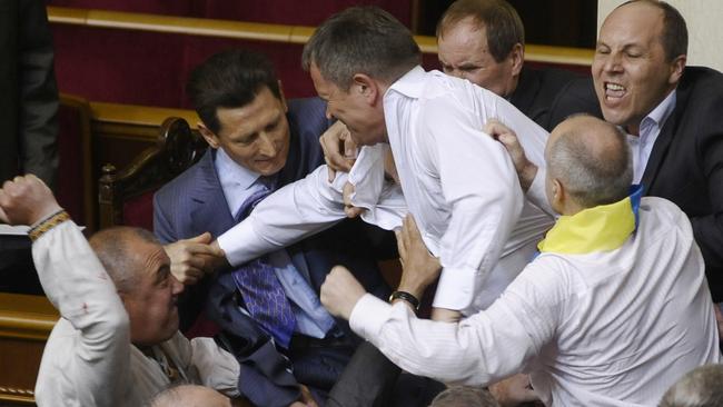 Lawmakers from pro-presidential and oppositional factions fight in the parliament session hall in Kiev, Ukraine in 2012.