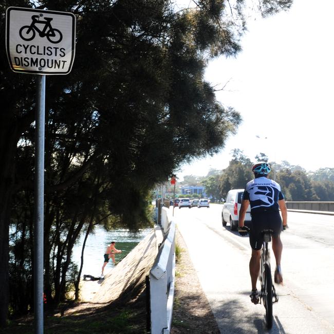 Cyclist are meant to get off their bikes when using the footpath across the Pittwater Rd bridge over Narrabeen Lagoon. Picture: Victoria Young