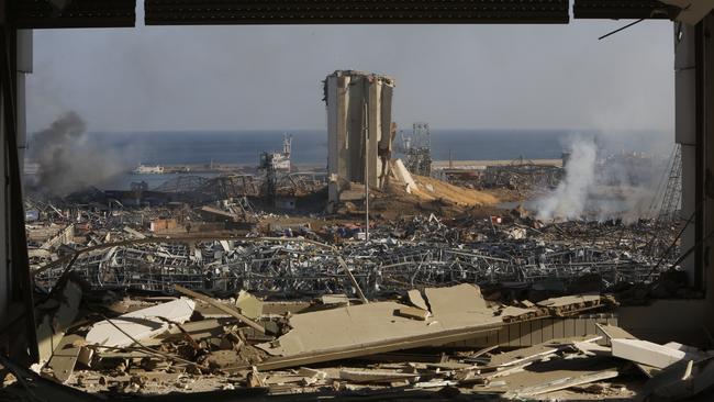 Smoke rises above wrecked buildings at Beirut’s port. Picture: Getty Images