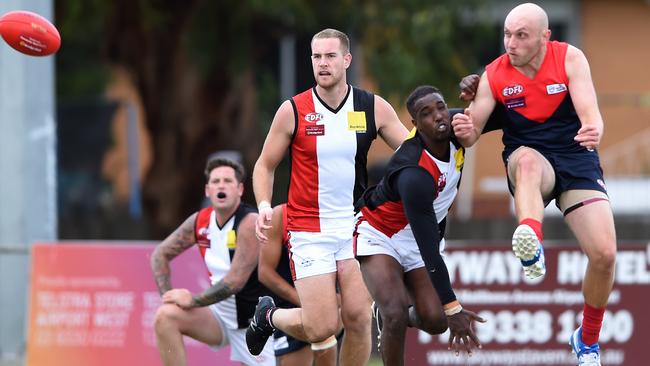 Dean Bartrop gets a kick away for Tullamarine. Picture: Steve Tanner