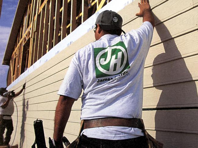 Construction worker wearing James Hardie logo top while building house Aug 2000.