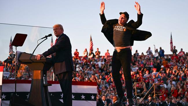 Tesla CEO Elon Musk jumps on stage as he joins former US president and Republican presidential candidate Donald Trump during a campaign rally in Pennsylvania on October 5. Picture: AFP