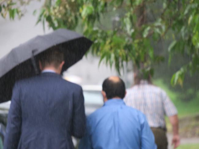 Doctor Fady Malak, 38, of Erina (blue shirt) leaving Gosford Local Court with his lawyer in January.